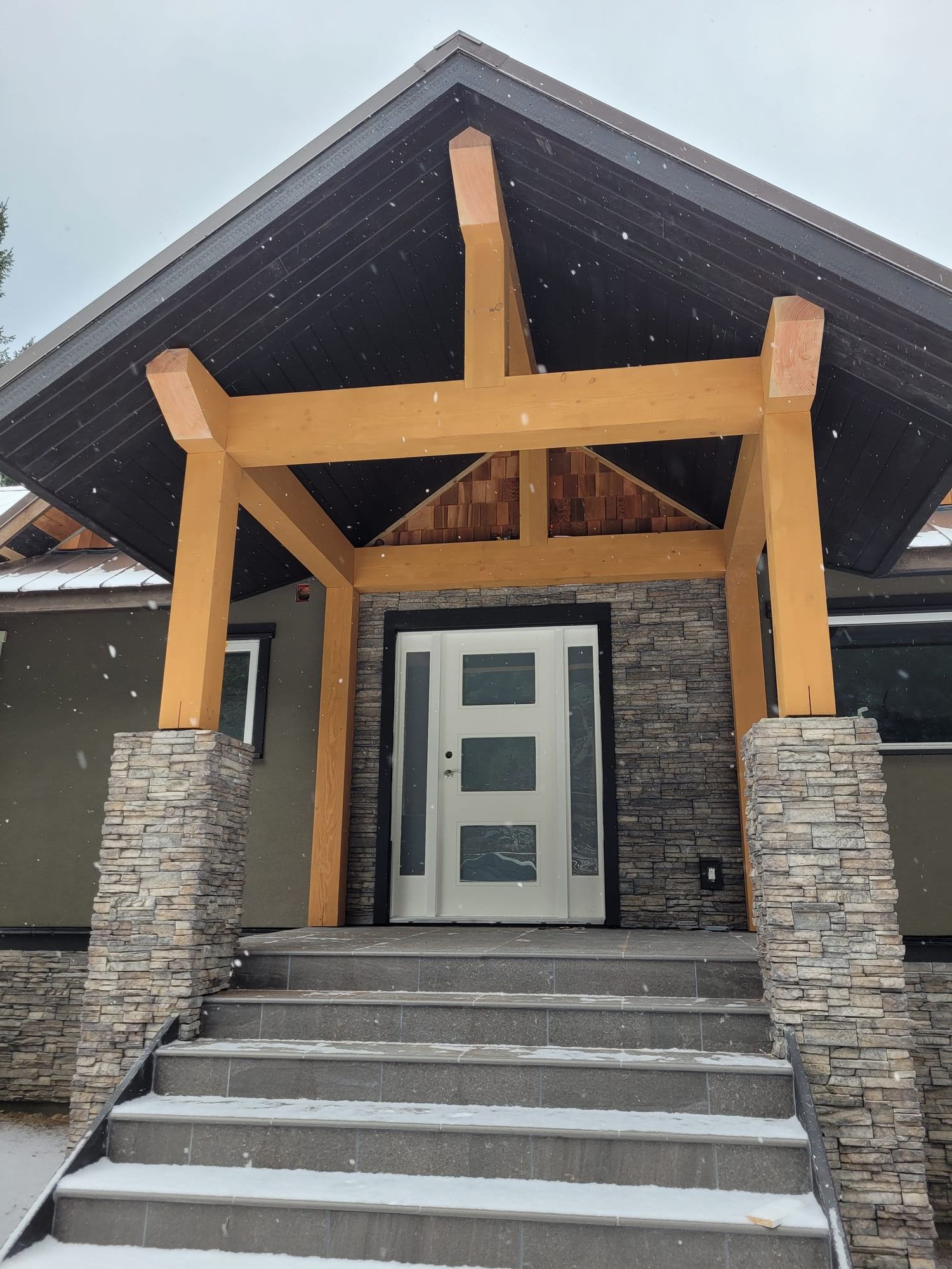 Timber frame entry addition — structural portal and stone cladding