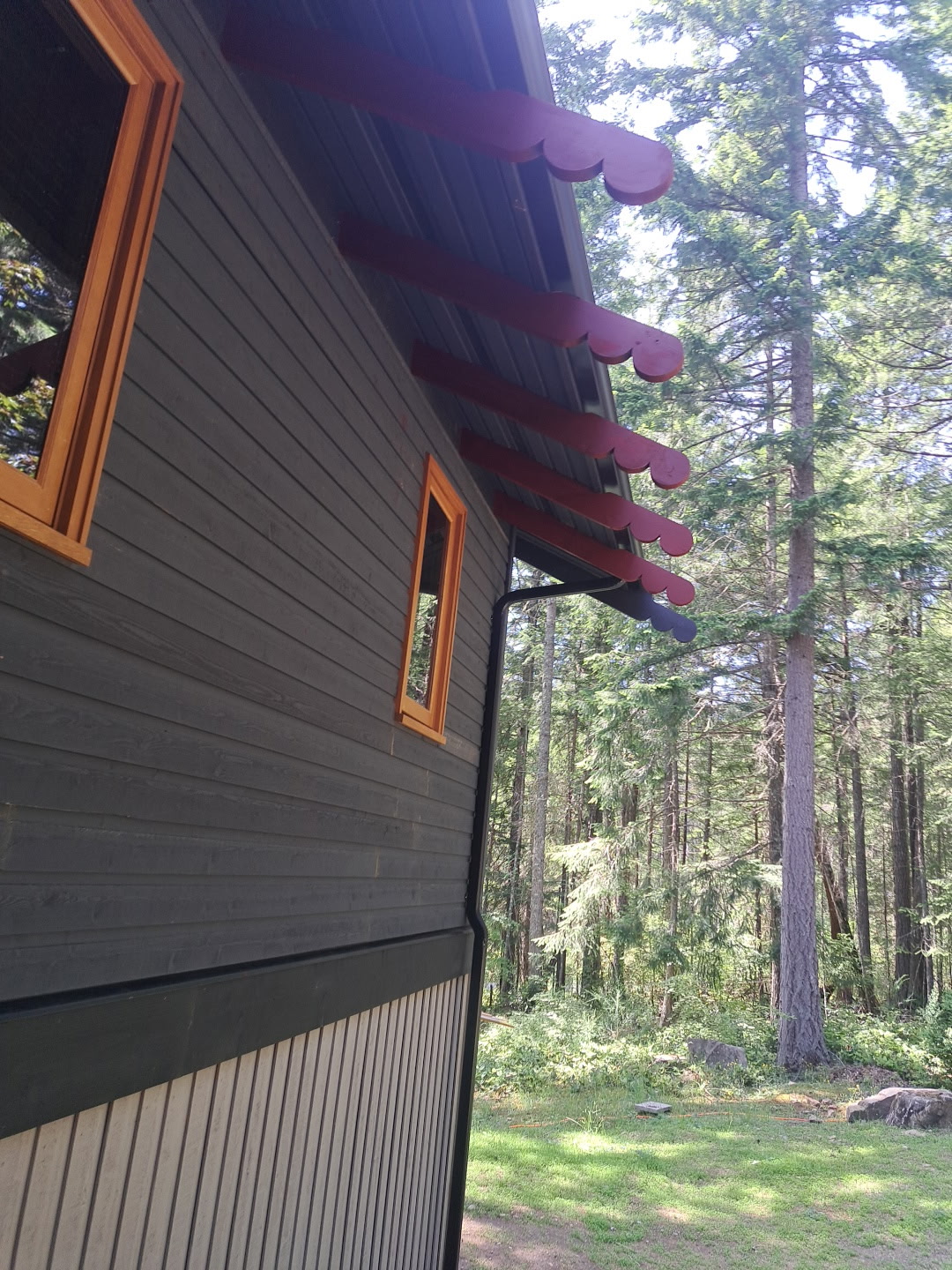Finished addition with exposed shaped rafter tails and wood-trimmed window