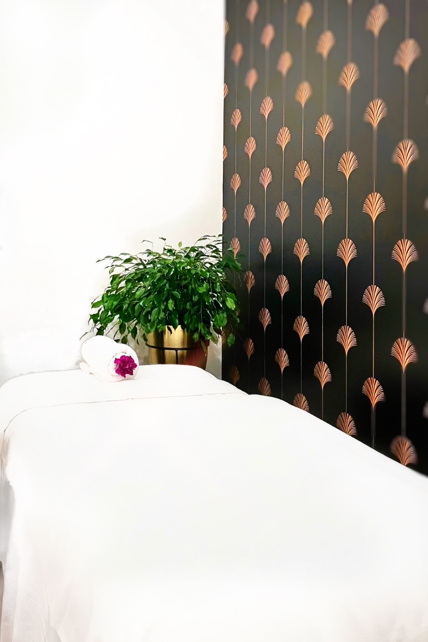 Treatment room with dark copper leaf patterned feature wall