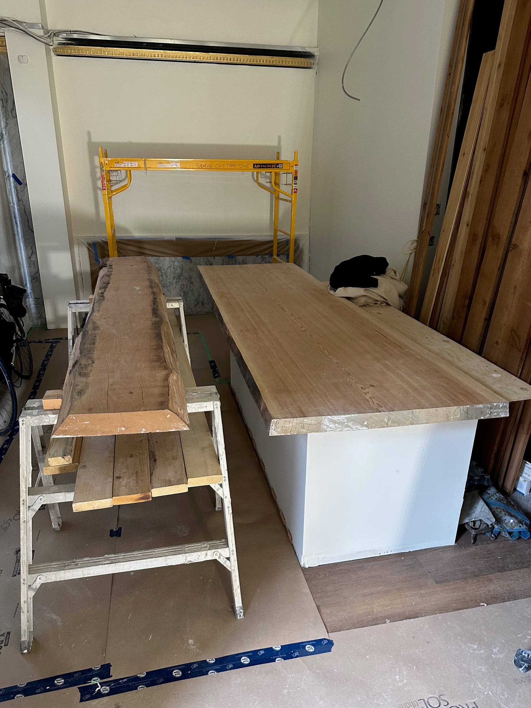 Locally sourced live-edge material being fitted during construction
