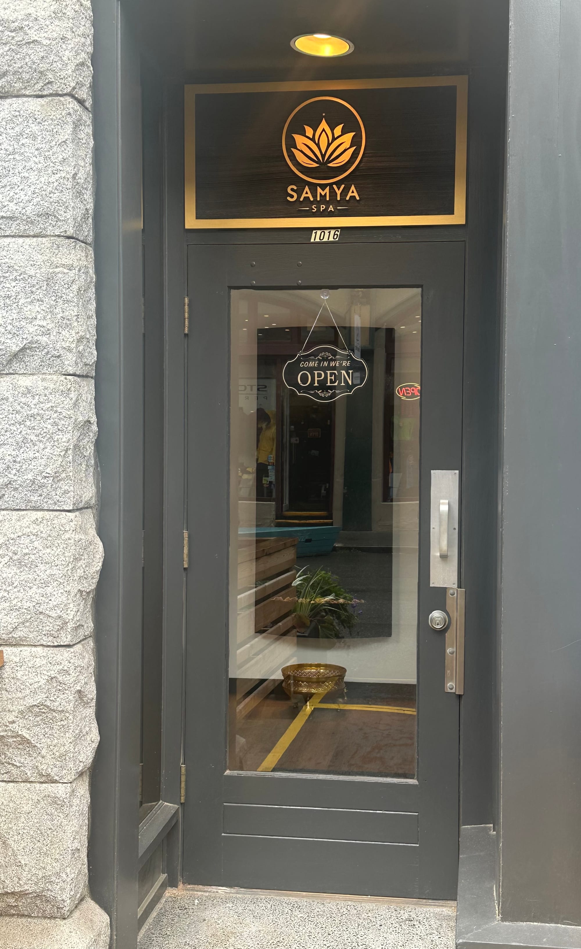 Completed Samya Spa entrance with stone surround and branded glass door