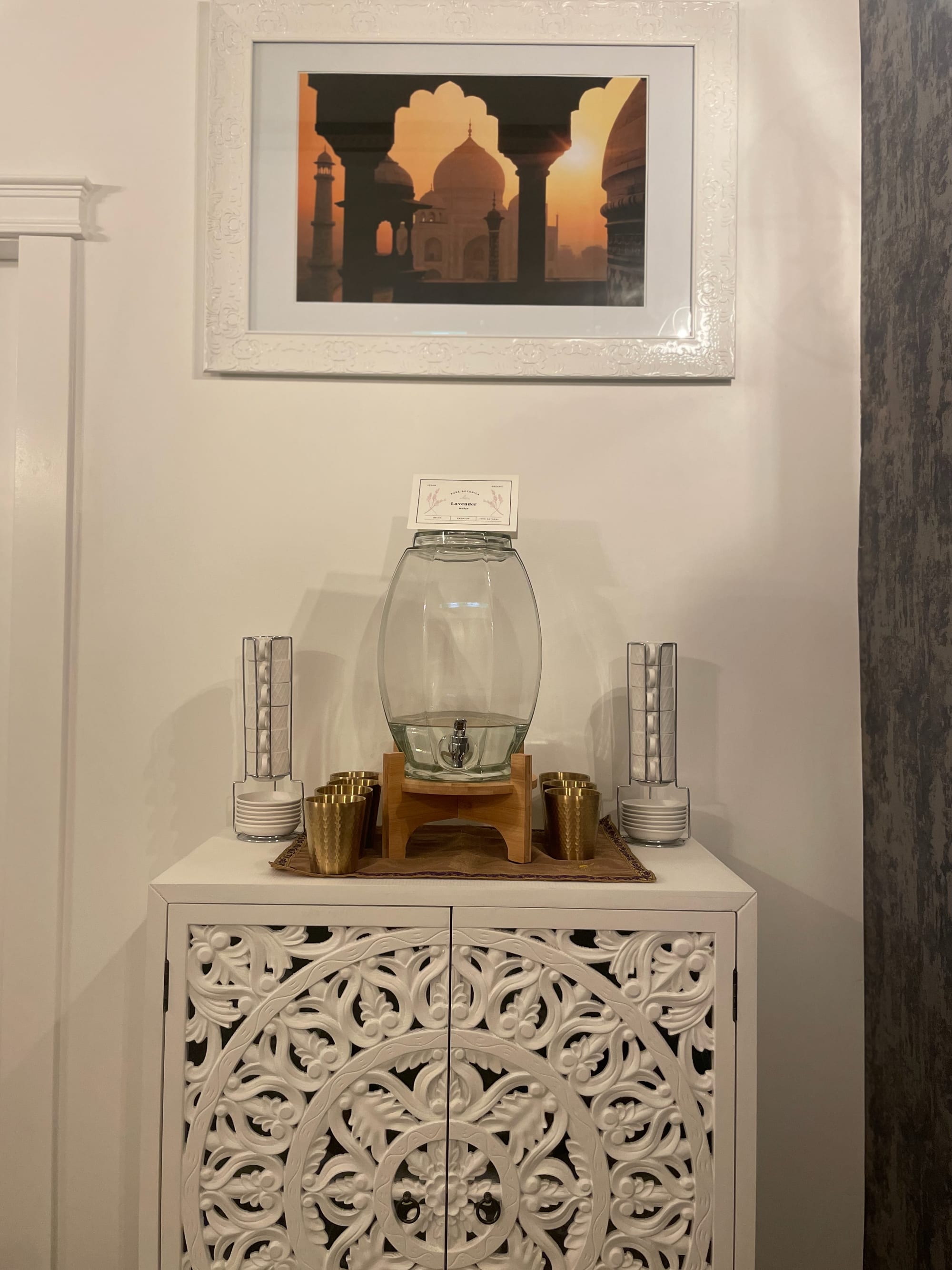 Completed water station with decorative artwork and coordinated cabinetry