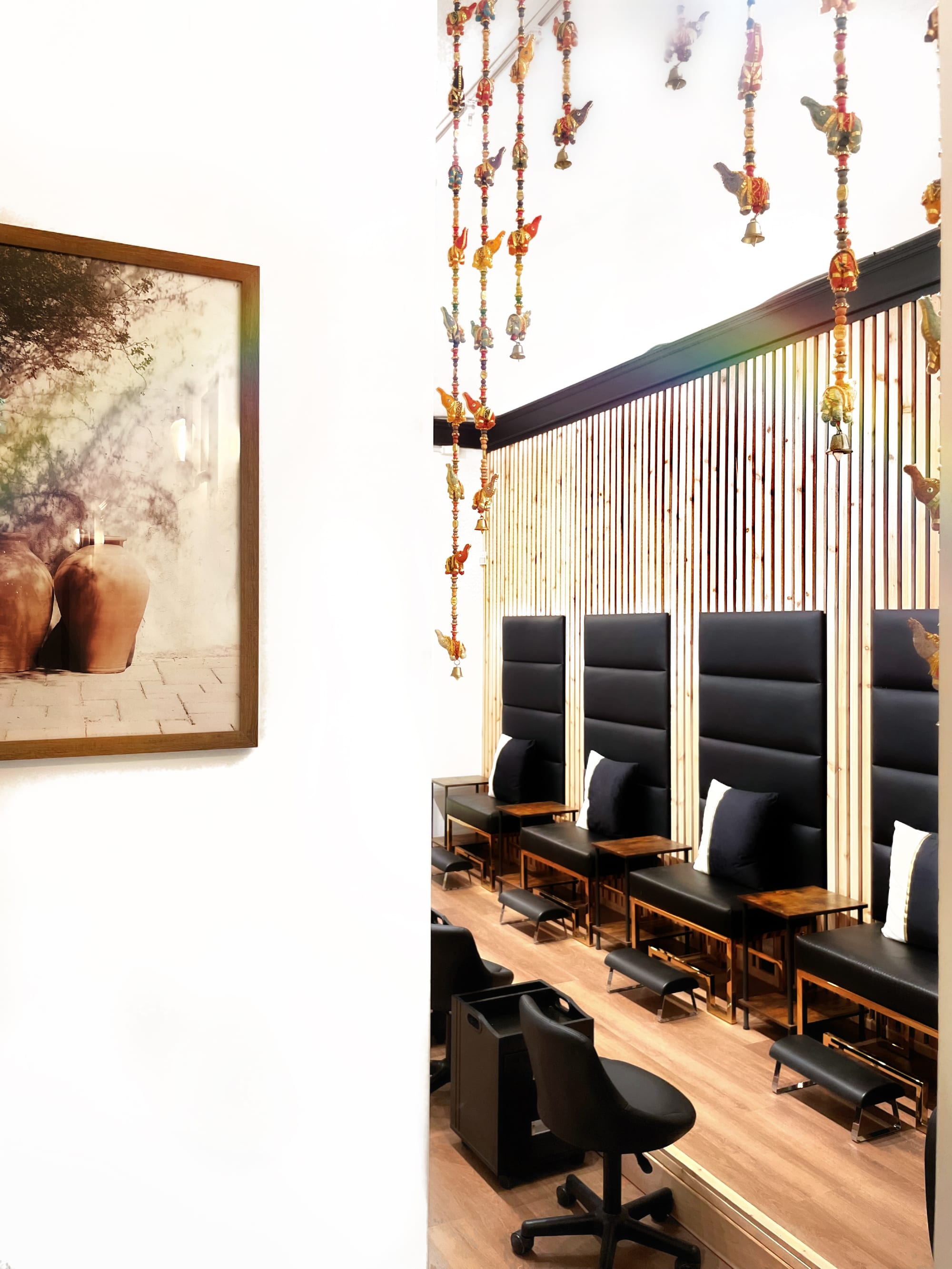Completed pedicure area with elevated stations and vertical timber screens