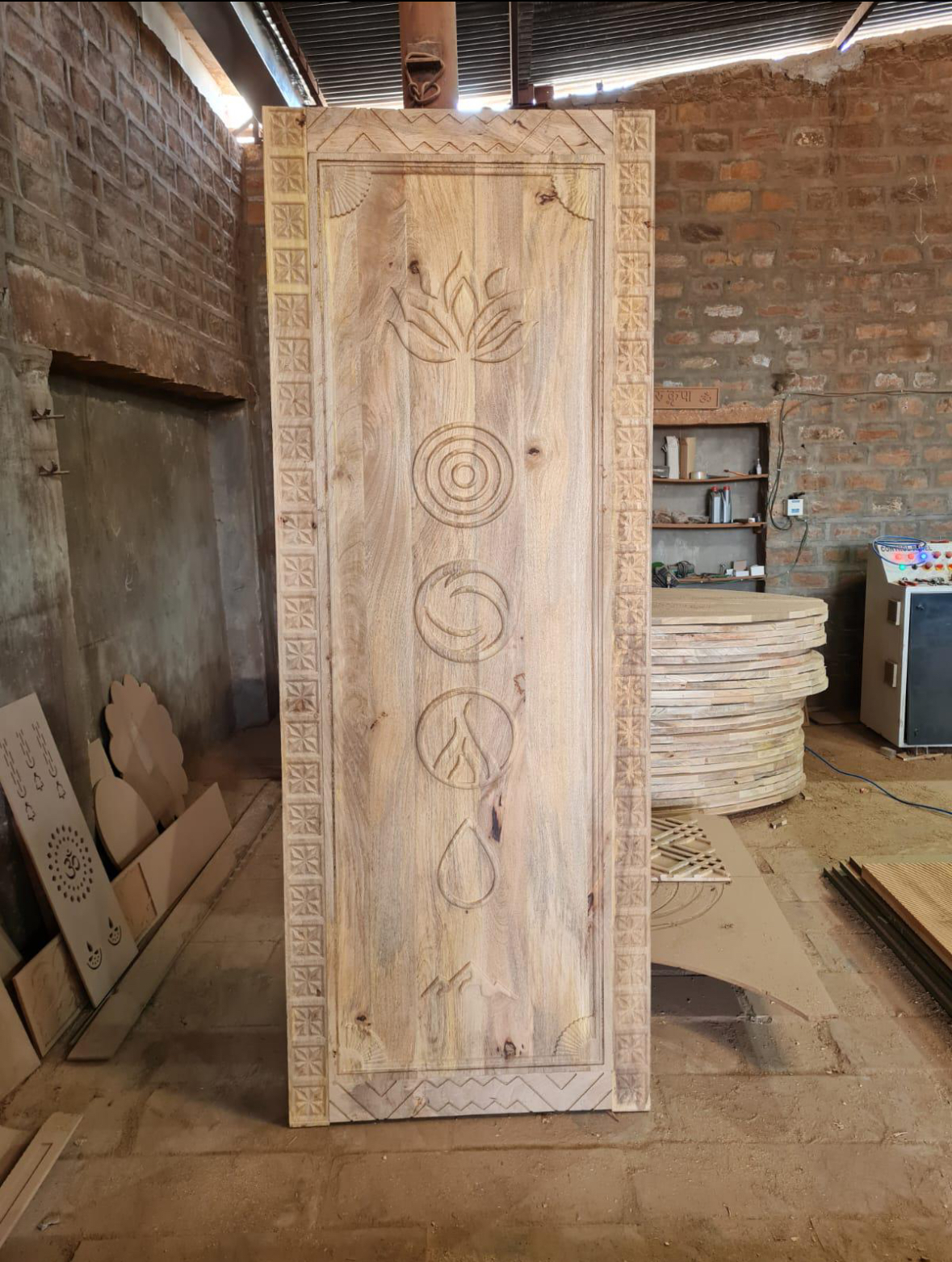 Carved entry panel in fabrication at the workshop before finishing