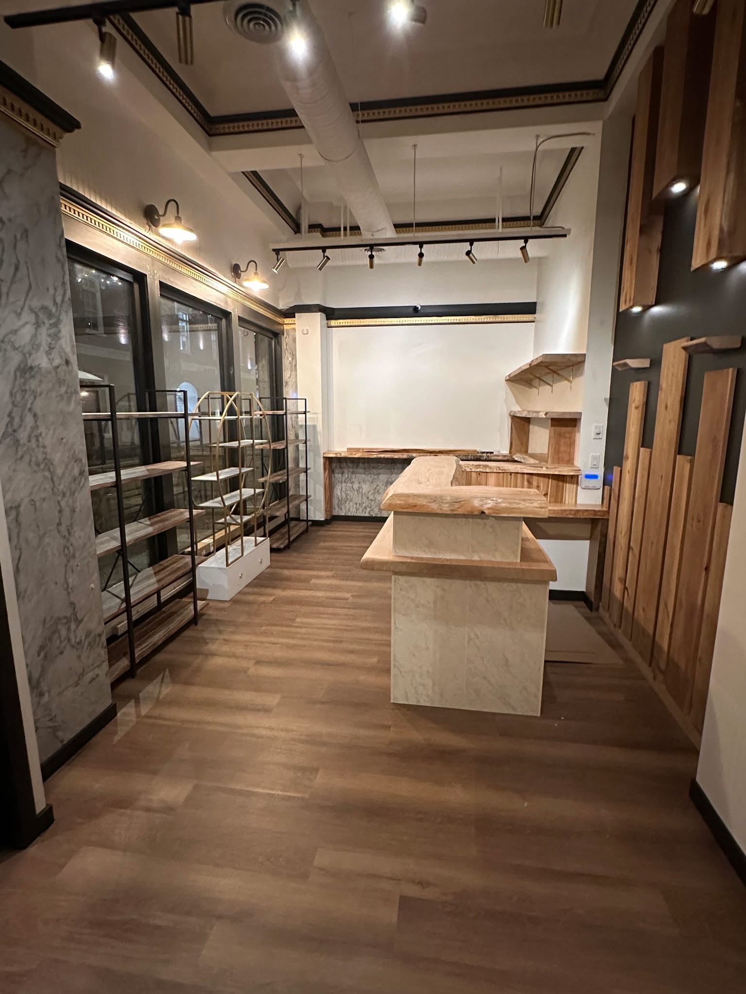Completed Samya Spa reception fit-out with custom counter, retail shelving, millwork and track lighting
