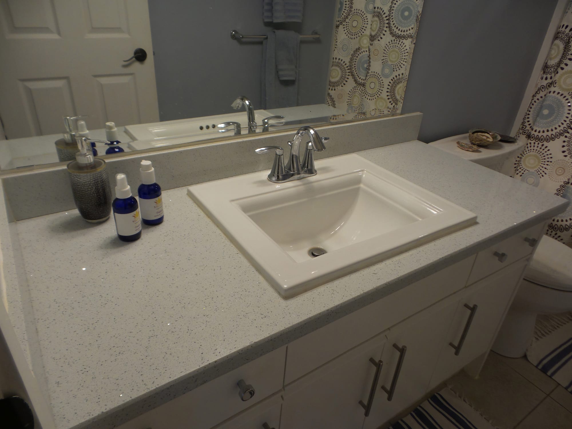Completed washroom vanity with tiled backsplash and integrated sink