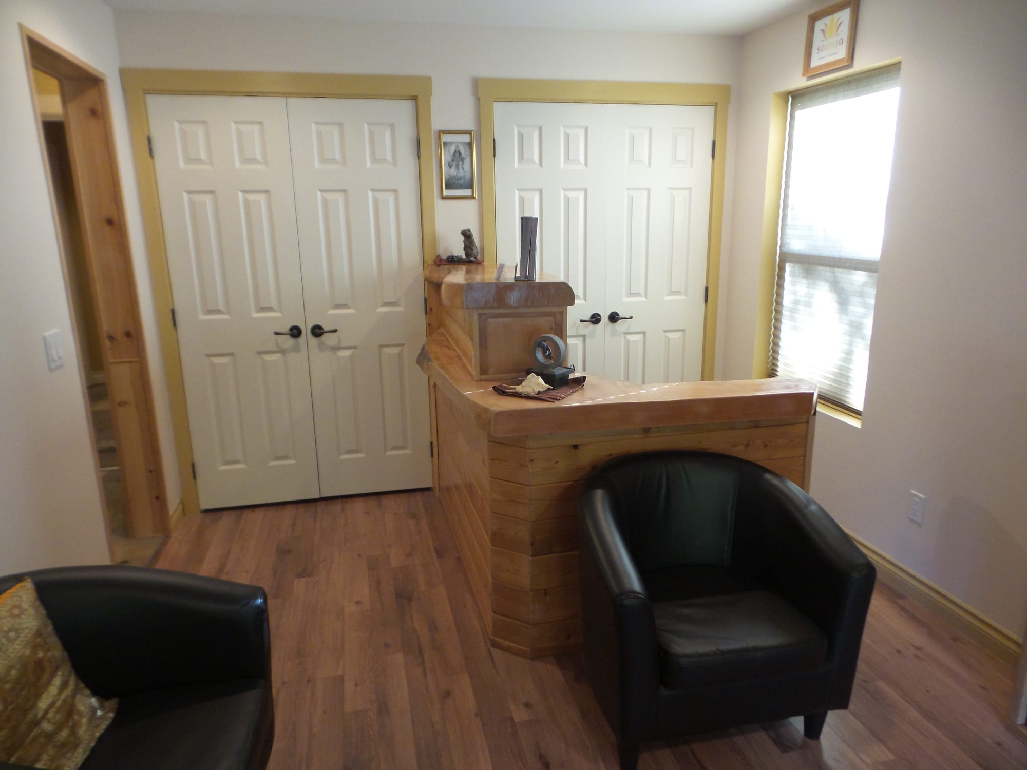 Reception lobby — custom cedar desk and hardwood flooring