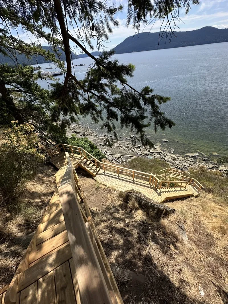 Site-scale cedar stair and pathway system constructed across a steep coastal property
