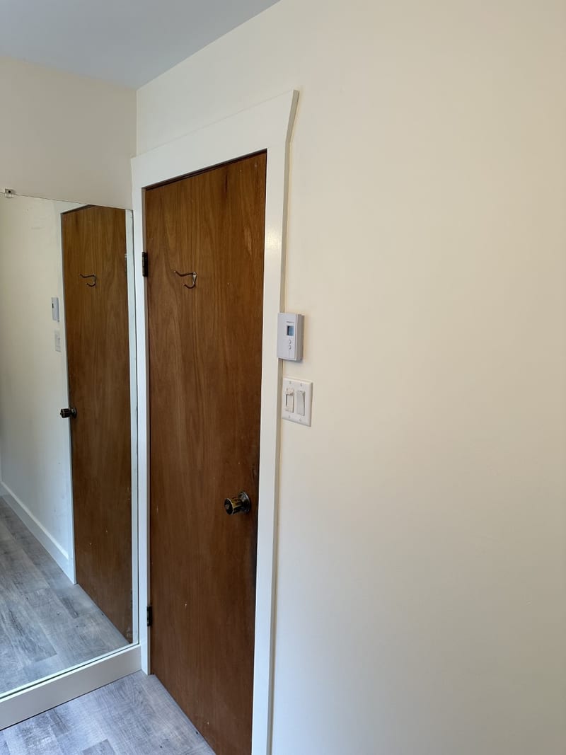 Finished bathroom with tub-and-shower combination and illuminated mirror