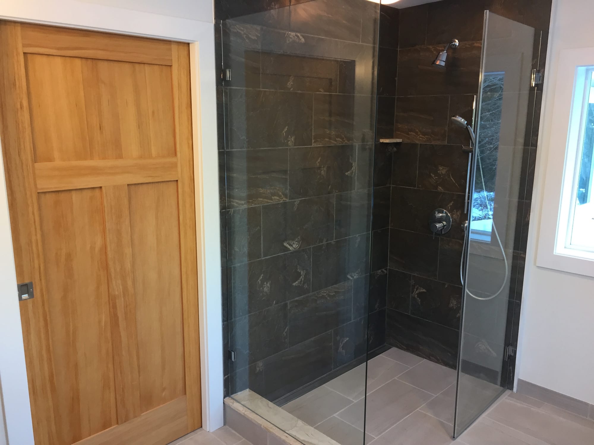Finished grey bathroom interior with glass shower