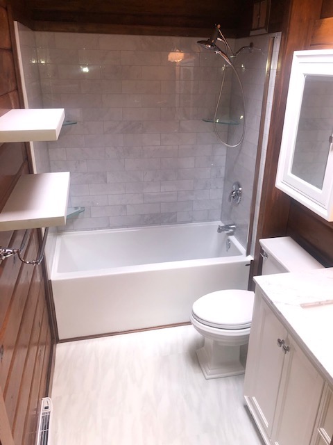 Warm wood bathroom walls and white vanity detail