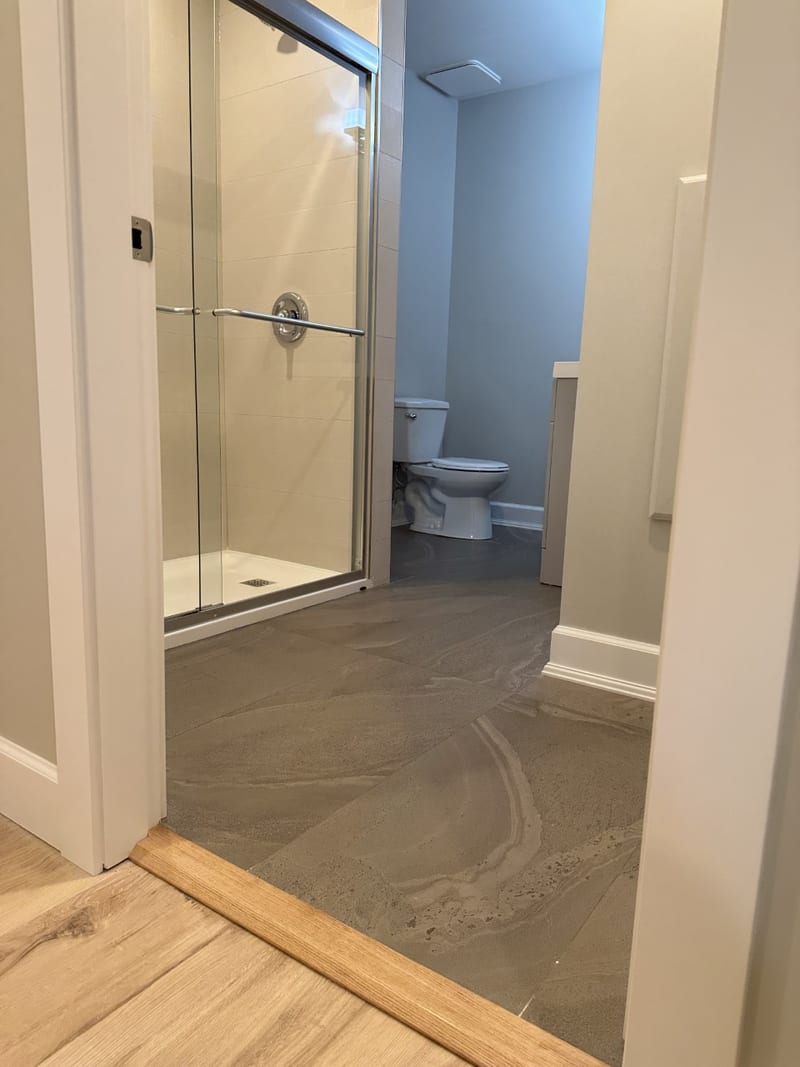 Heritage home renovation — bathroom with tile floor and shower enclosure
