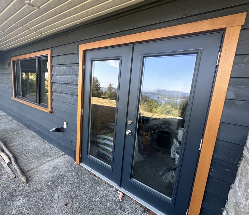 Ocean view estate — dark exterior siding with cedar-trimmed french doors and ocean view